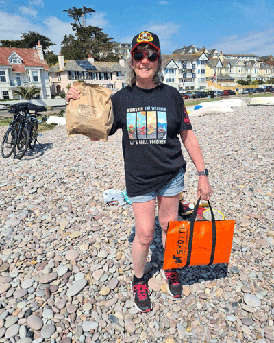 Sue in Big K top on the beach